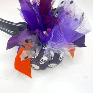 Handmade Skull Glow in the Dark pumpkin in black, white, purple, and orange.